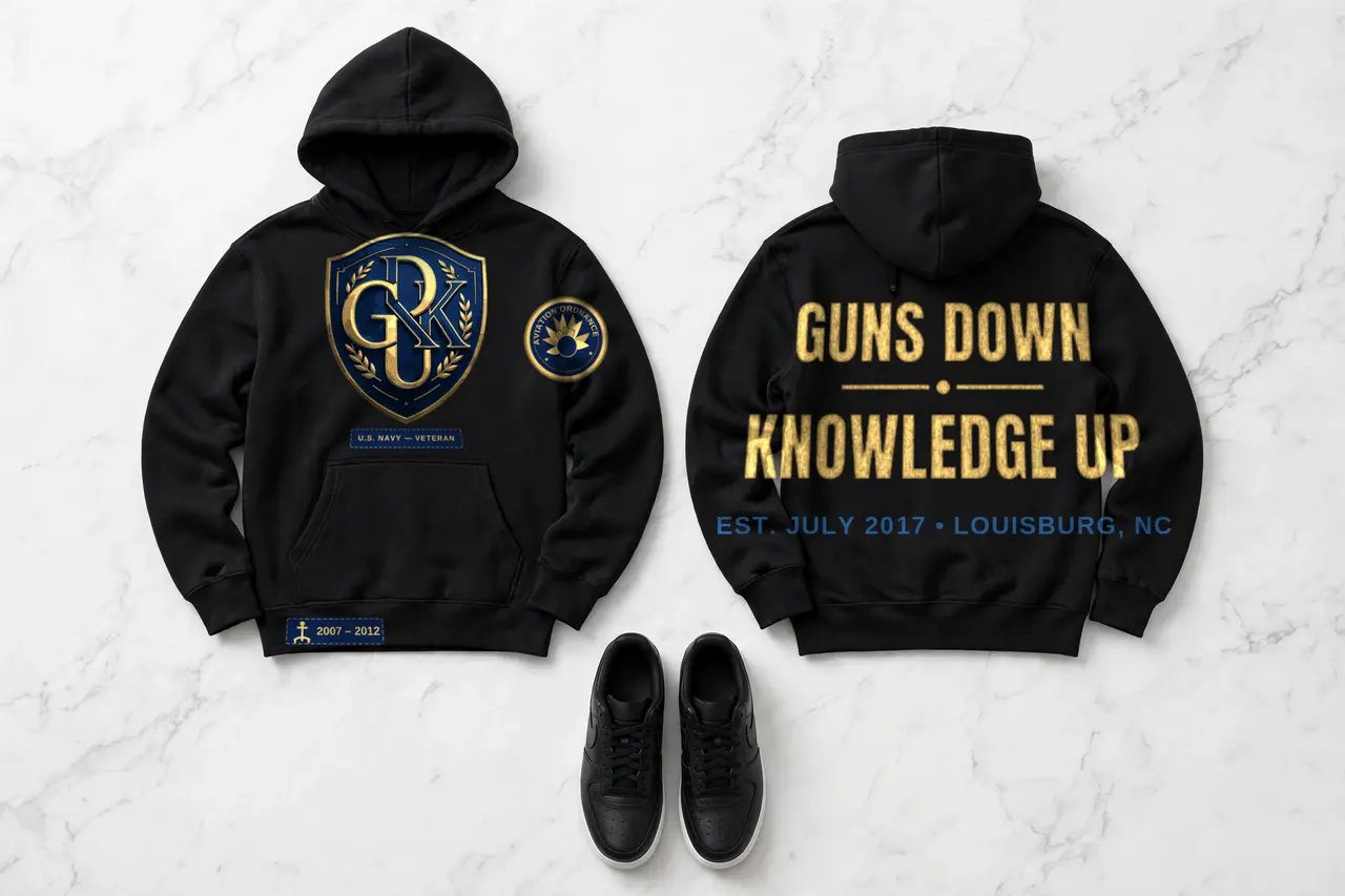 G.D.K.U. hoodie — navy and gold shield crest on the front, Guns Down Knowledge Up across the back, Est. July 2017 Louisburg NC
